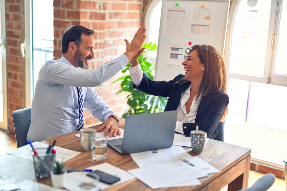 Two people celebrating at a desk